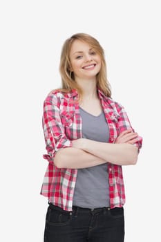 Front view of a woman smiling while standing against a white bckground