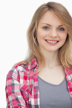 Blonde woman smiling against a white background