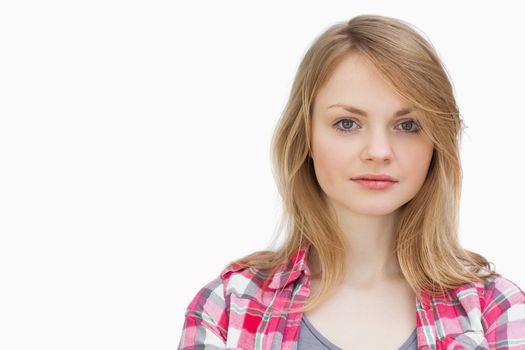Blonde woman looking at camera against a white background