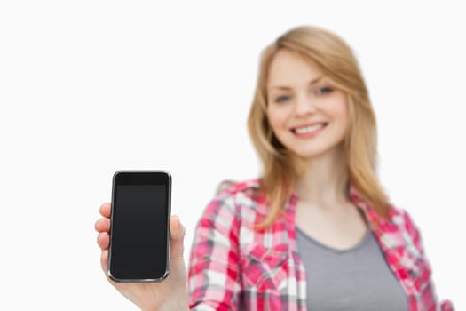 Woman showing a smartphone against a white background