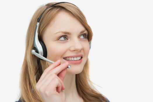 Woman with headset looking up against a white background