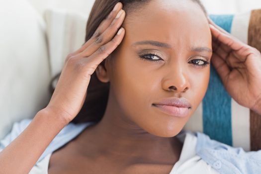Black woman having pains on a living room