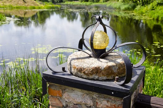 original lamp on millstone near tourism farm pond