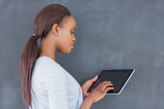 Side view of a woman using a tablet computer in a classroom