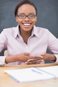 Teacher having fingers crossed in a classroom