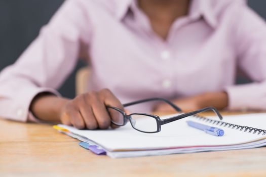 Close up of a notebook and glasses in a classroom
