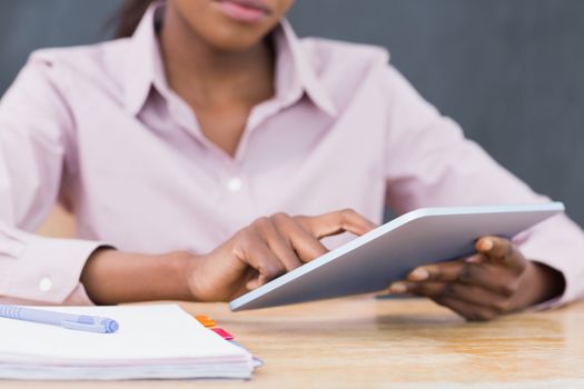 Close up of a teacher using a tablet computer in a classroom