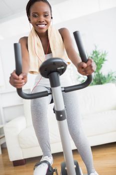 Black woman smiling while doing sport in a living room