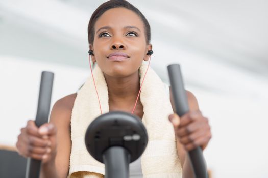 Low angle view of a black woman doing exercise bike in a living room