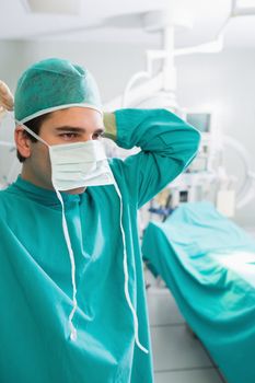 Close up of a surgeon putting his mask in an operating theatre