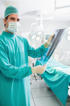 Surgeon holding a X-ray in an operating theatre