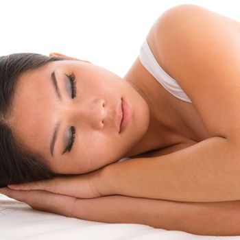 Beautiful young Asian woman asleep, on white background