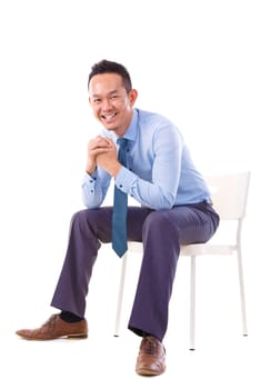 Full body Asian business man sitting on a chair over white background