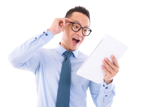 Surprise Asian business man looking at tablet computer, isolated over white background