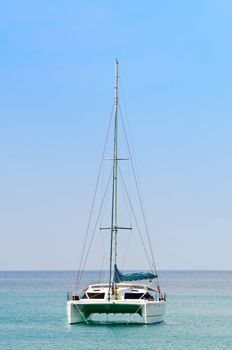 Luxury white sail catamaran boat in the sea with blue sky 