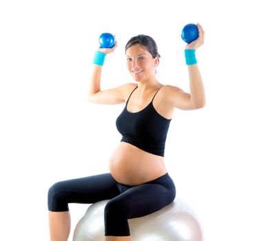 Beautiful pregnant woman at fitness gym with toning balls on aerobics