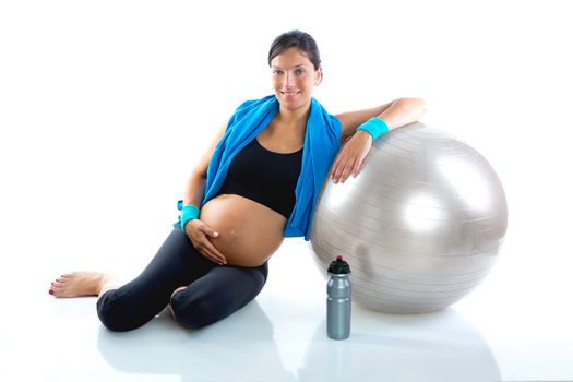 Beautiful pregnant woman at fitness gym relaxed with aerobics ball