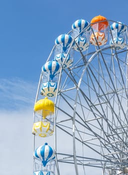 Ferris wheel in blue sky.