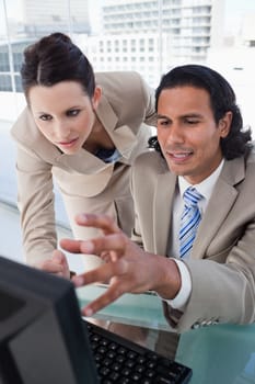 Portrait of a business team using a monitor in an office