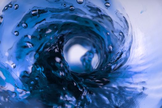 Whirlpool from a glass bottle with a blue light