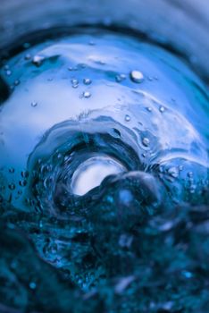 Inside bottle shot while pouring blue liquid