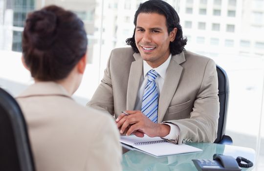 Manager interviewing a female applicant in his office