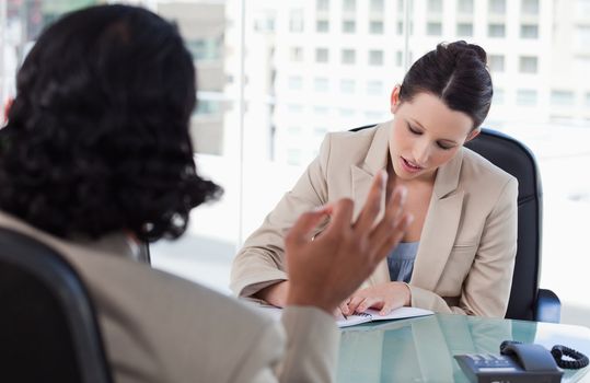 Manager interviewing a male applicant in her office