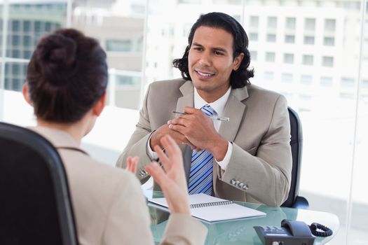 Happy manager interviewing a female applicant in his office
