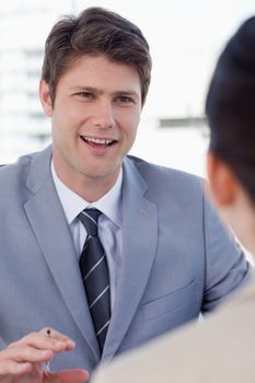 Portrait of a smiling manager interviewing a female applicant in an office