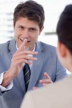 Portrait of a handsome manager interviewing a female applicant in his office