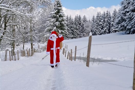 Santa Claus, Father Christmas in a beautiful winter landscape