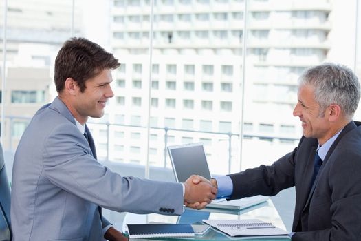 Businessmen shaking hands in an office