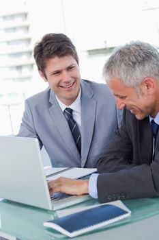 Portrait of businessmen working with a notebook in an office