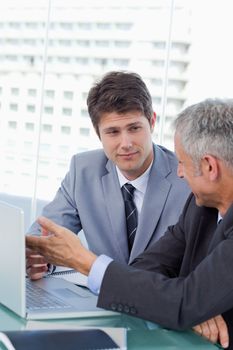 Portrait of serious businessmen working with a laptop in an office