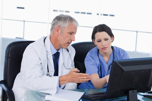 Professional medical team working with a computer in an office