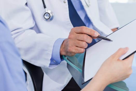 Close up of a medical team looking a document in an office