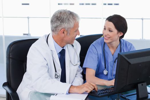 Medical team working with a computer in an office