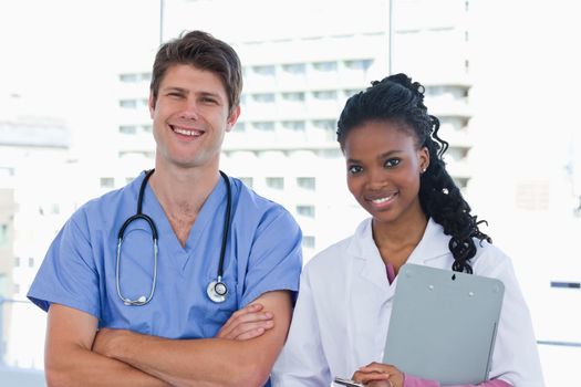 Happy doctors standing up in an office