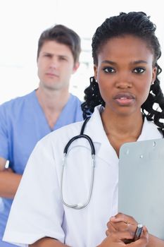 Portrait of serious doctors standing up in an office