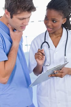 Portrait of doctors looking at a document in an office