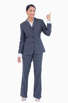 Businesswoman pointing up against a white background