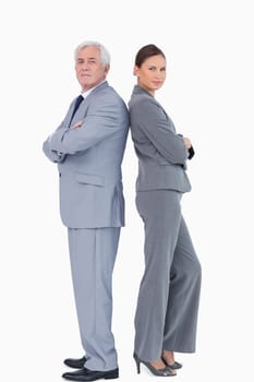 Businessteam standing back to back against a white background