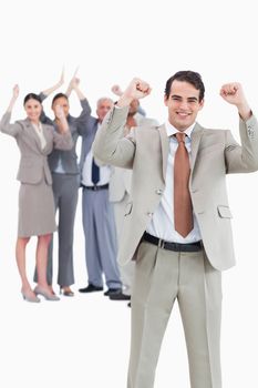 Cheering businessman with team behind him against a white background