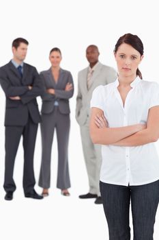 Tradeswoman with arms folded and three colleagues behind her against a white background