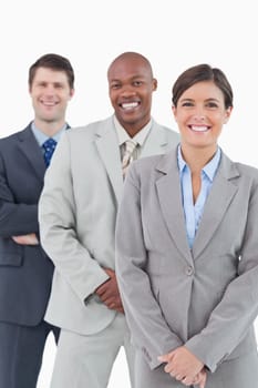 Smiling salesteam standing together against a white background