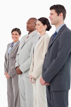 Smiling saleswoman standing next to her colleagues against a white background