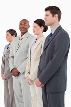 Smiling businessman standing between his colleagues against a white background