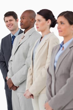 Smiling salesman standing next to his associates against a white background
