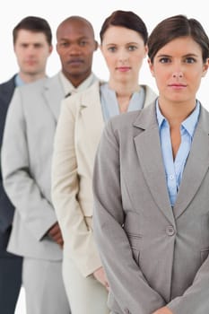 Serious looking businessteam standing together against a white background