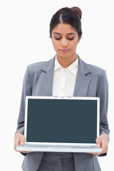 Businesswoman looking at notebook in her hands against a white background